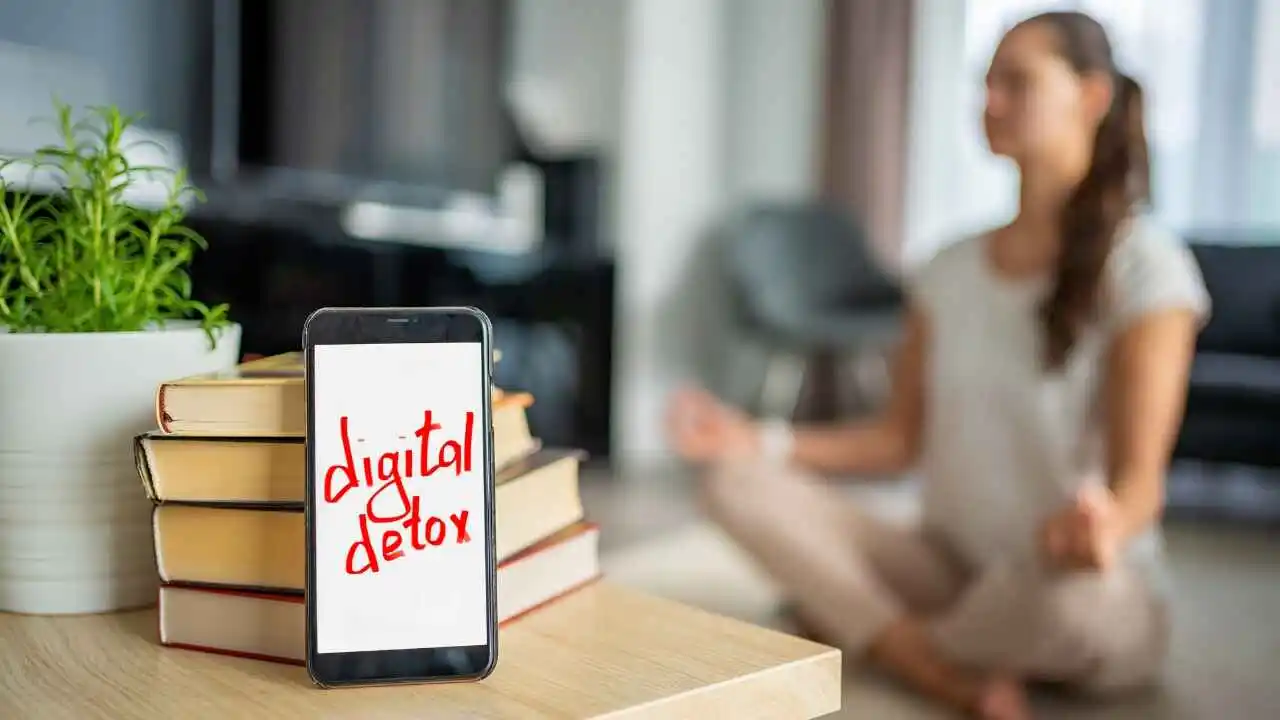 a phone on a table with a stack of books